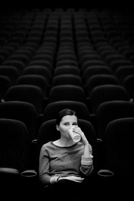 woman alone at cinema film black and white photograph