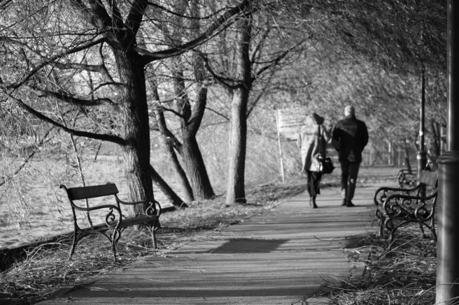 man and woman walking bucharest black and white