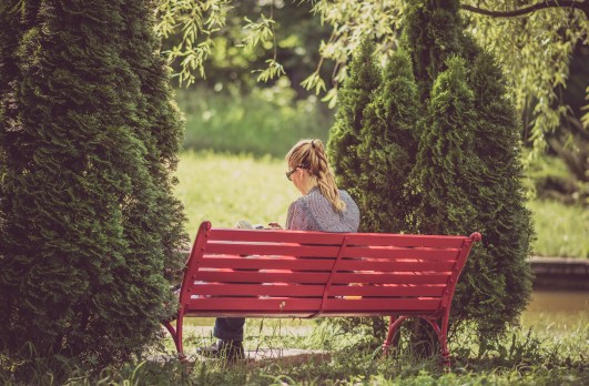 woman on bench reading