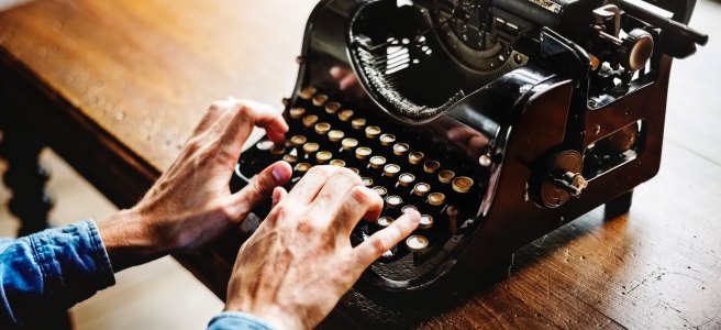 How to write more - man typing old typewriter