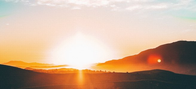 Sunset over hills. blue sky